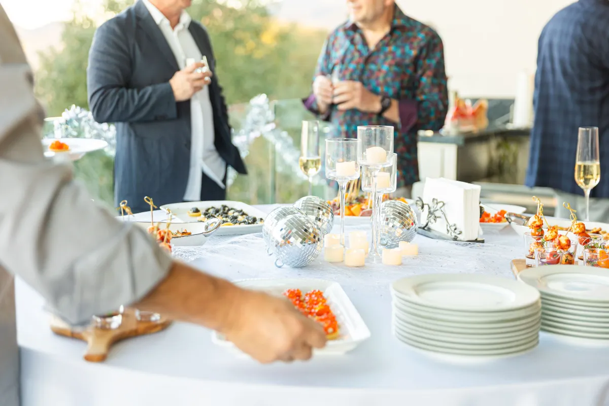 Chef Nikita Botberg serving guests at a 40th anniversary celebration